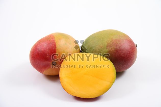 Two and half Mangoes isolated on white background - бесплатный image #187793