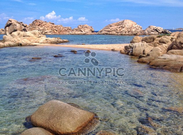 Rocks on the beach and crystal clear sea water, Sardinia island, Italy - image #297483 gratis