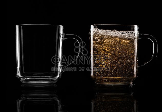 Glass cups on black background - бесплатный image #303223
