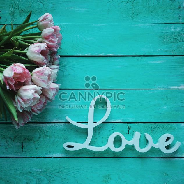 Tulips and word Love on green wooden background - бесплатный image #329303