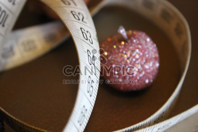 Still life of white measure tape with pink glitter toys - image gratuit #341453 