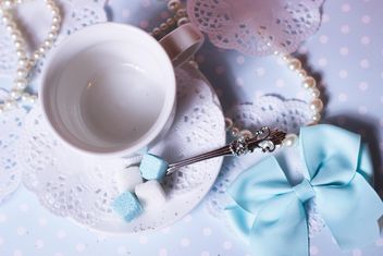 White cup and decorations on table - бесплатный image #342083