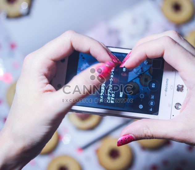 Smartphone decorated with tinsel in woman hands - image gratuit #342173 