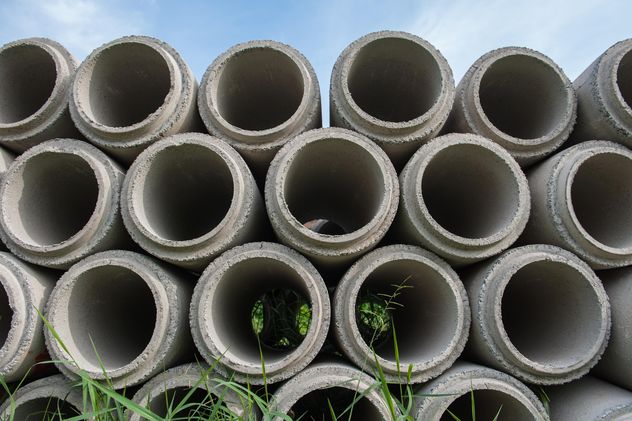 Concrete drainage pipes stacked on construction site - Free image #344583
