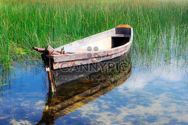Old boat on river with reflection of sky - Free image #345063