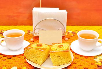 Two cups of tea and cakes on table - бесплатный image #346553