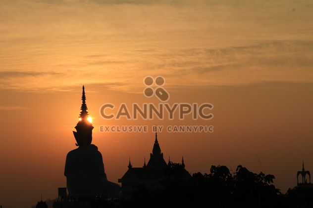 Silhouette of Buddha statue and temple at sunset - Free image #346573