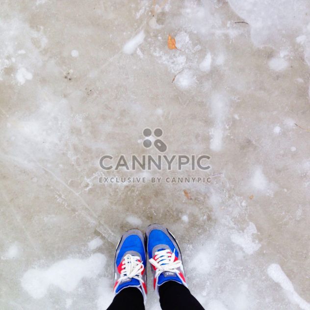 Feet in colorful sneakers on ice - бесплатный image #347173