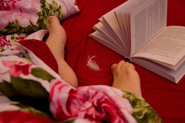 Human feet and open book in bed - Free image #347983