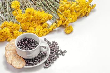 Cookies, cup of coffee beans and flowers over white background - Free image #452433