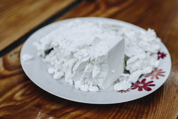 Feta cheese in a white plate on wooden background - Kostenloses image #454873