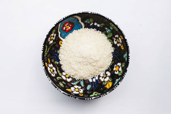 Top view of shredded parmezan cheese in a colorful bowl. - image #456213 gratis