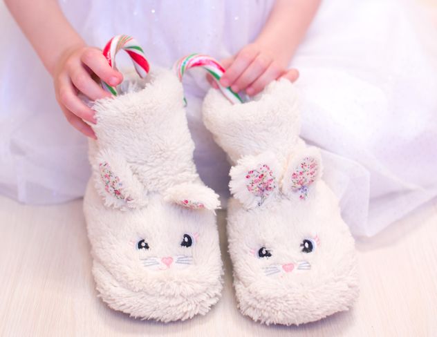 Warm slippers with candies in child's hands - image gratuit #182553 