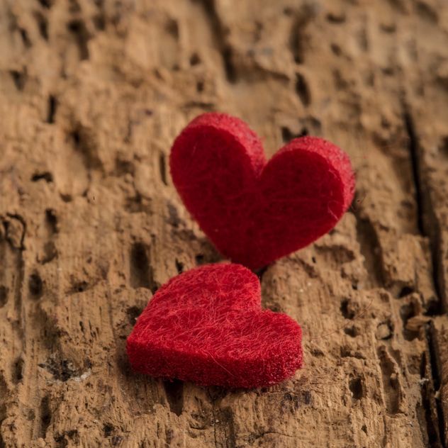 Felted hearts on wooden surface - бесплатный image #182943