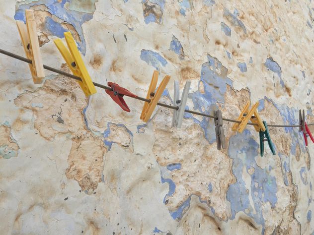 colorful clothespins hanged against wall - image #183143 gratis