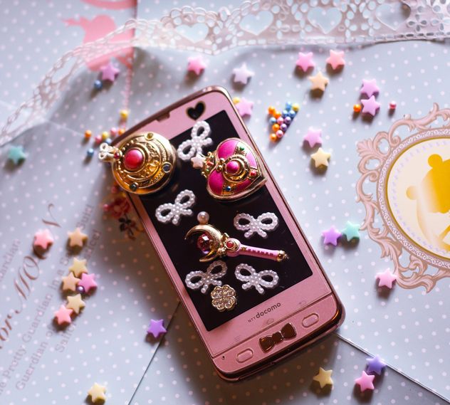 pink smartphone with little white hearts and and bows on white background - бесплатный image #187263