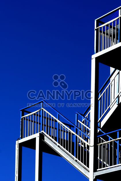 Stairs against a blue sky - image #187693 gratis
