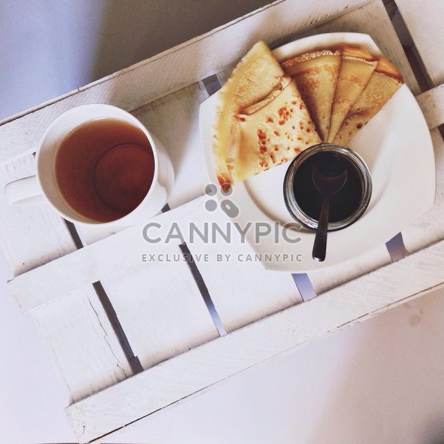 Pancakes with jam and cup of tea - бесплатный image #198493