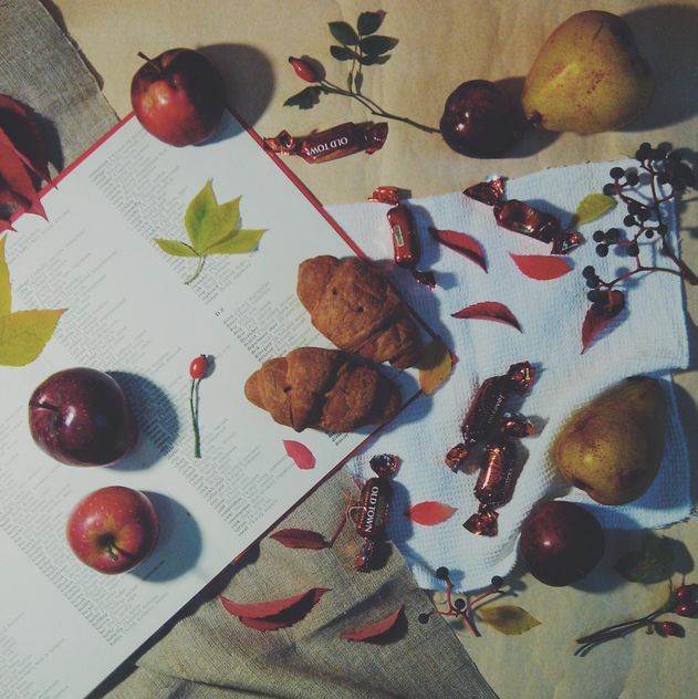 Open book, apples, candies and croissants on the table, #apples - image gratuit #272163 