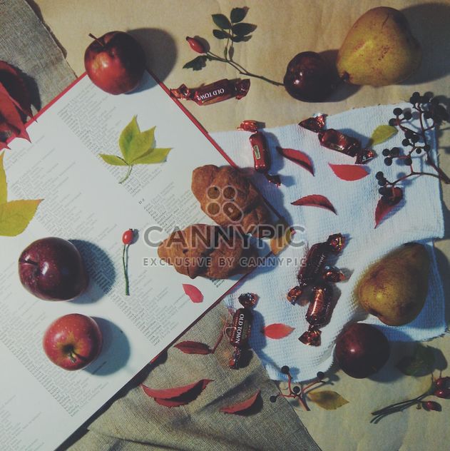 Open book, apples, candies and croissants on the table, #apples - бесплатный image #272163