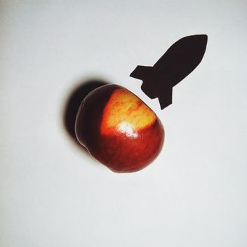 Apple and silhouette of a rocket on white background - image #272233 gratis