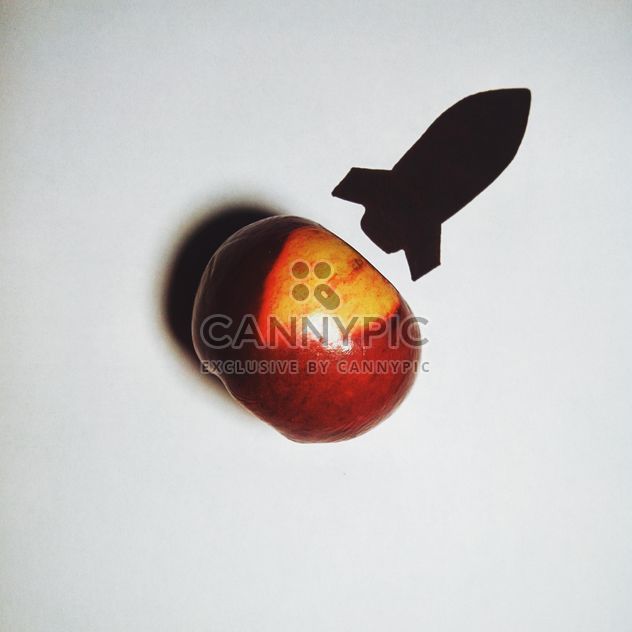 Apple and silhouette of a rocket on white background - image #272233 gratis