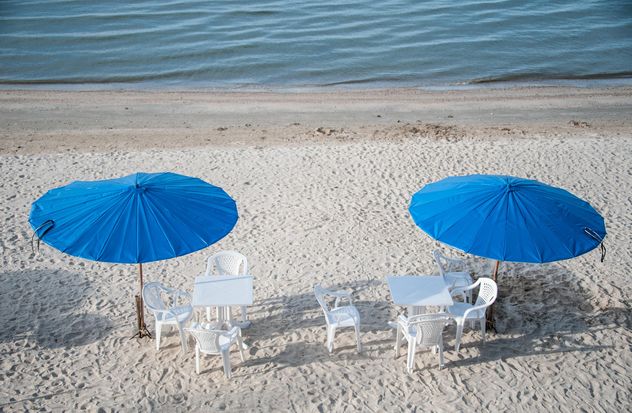 Tables and chairs on beach - Free image #275103