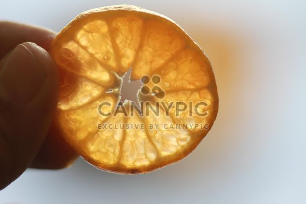 Orange slice in a hand - Kostenloses image #301943
