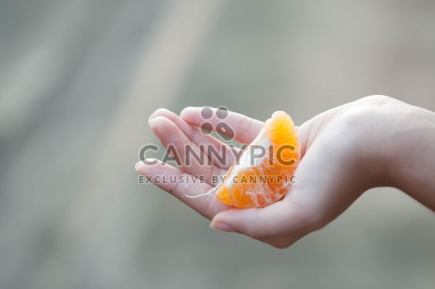 peeled tangerine in hand - Free image #301973