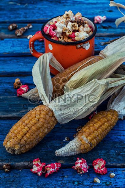 Corn and pop-corn on wooden background - бесплатный image #302053