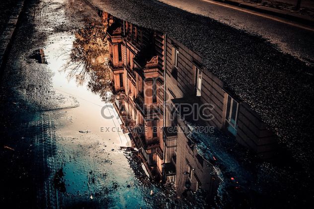 Reflection of houses in puddle - Free image #317403