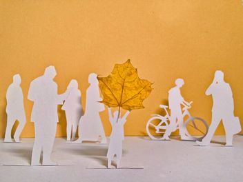 papercut people and yellow maple leaf - бесплатный image #330353