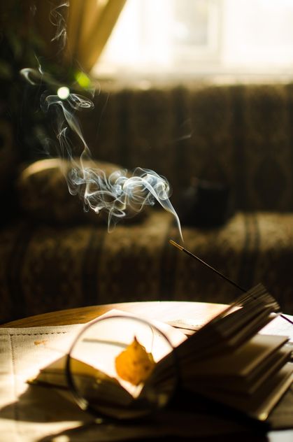 Autumn yellow leaves through a magnifying glass and incense sticks and book - Free image #330403
