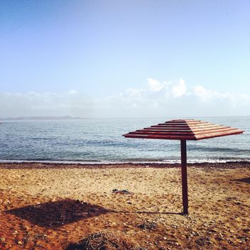 Beach umbrella on seashore - Free image #331763