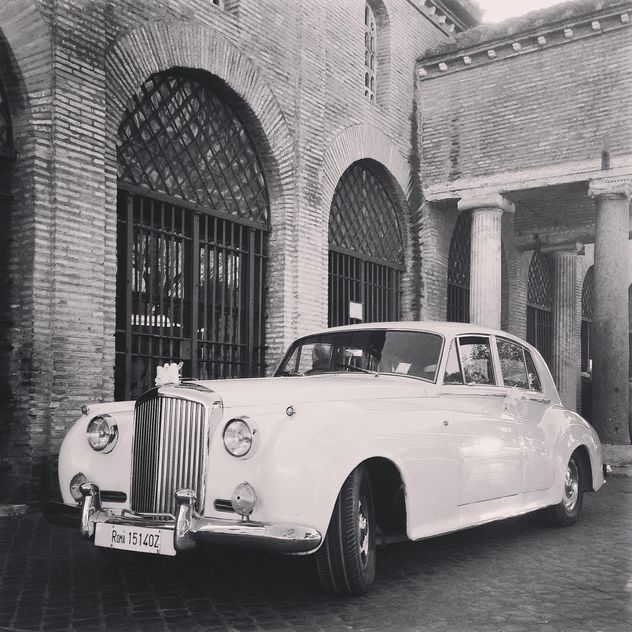 White Bentley near old brick building, black and white - Free image #331833