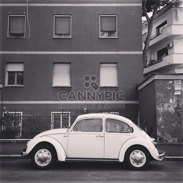 Old Volkswagen car near the house, black and white - бесплатный image #331953