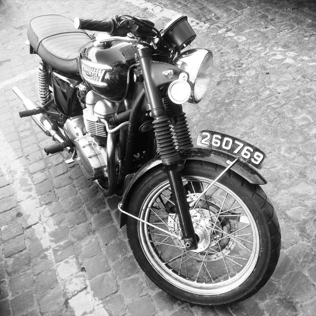 Triumph motorcycle on paving stone - image #332023 gratis