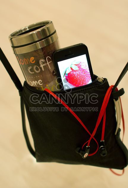 Cup of coffee and smartphone in handbag - image gratuit #337903 