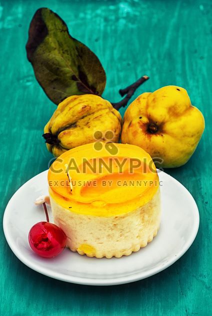 Yellow cake and quinces on green background - Free image #342913