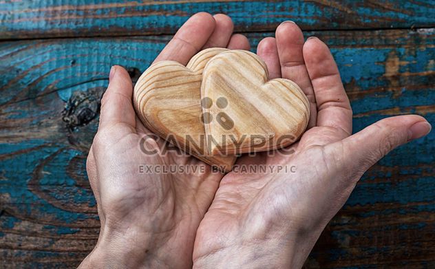 Wooden hearts in hands - image #342923 gratis