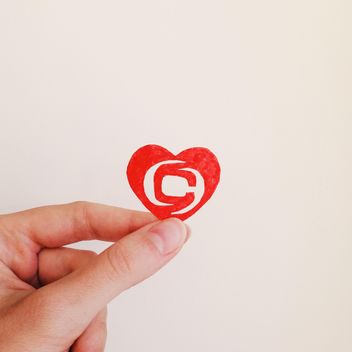 Paper heart with clashot logo in hand - image #345103 gratis