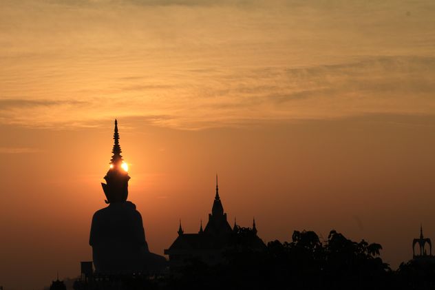 Silhouette of Buddha statue and temple at sunset - Free image #346573