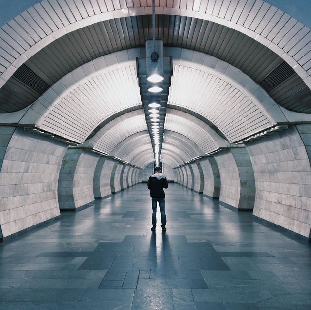 Lonely man in a subway station - image #363723 gratis