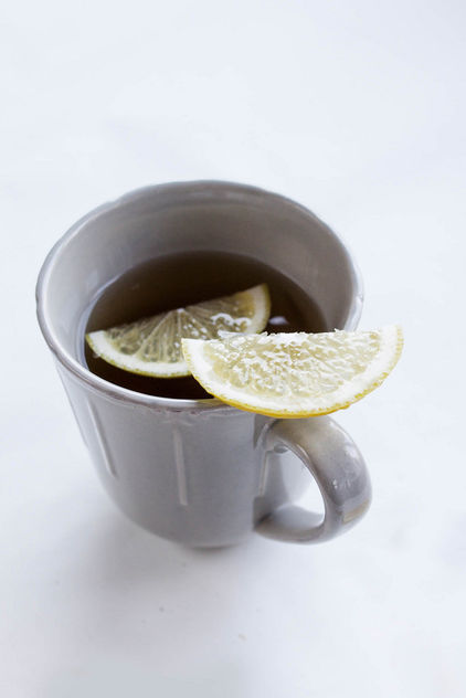 A cup of tea and a lemon slice - image #449003 gratis