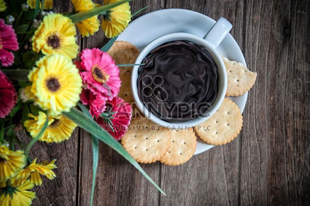 Cookies, cup of coffee and flowers on wooden background - image #452413 gratis