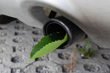 Fuel efficient car muffler with a green leaf - бесплатный image #455133